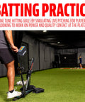 Person using All In One Baseball And Softball Training Aid With Spring Loaded Ball Launcher for batting practice indoors
