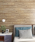 Wood Look Peel And Stick Vinyl Plank Flooring 6x36 Inches in a modern bedroom setting with pillows and lamp.