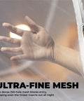 Close-up of hand through mesh of Pop Up Mosquito Net For Bed And Camping Indoor Outdoor Bug Mesh Shelter Lightweight Portable Tent