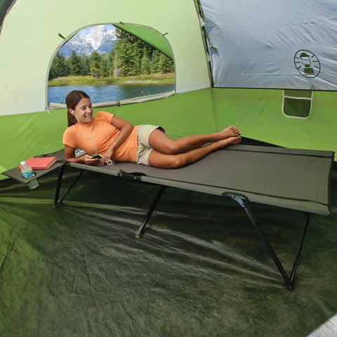 Pack-Away Big N Tall Camping Cot with Removable Side Table and Cup Holder inside tent, woman relaxing on extra wide cot