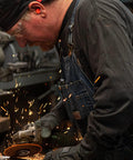 Worker using a grinder wearing an 8 Panel Welding Beanie Cap For Protection 100% Cotton Duck Canvas Exterior Heavy Duty Welder Hat For Men