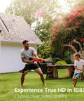 Outdoor WiFi Security Cam 1080p with Night Vision and Motion Detection on house wall, father and son playing outside