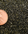 Close-up of fine abrasive blast media 20/40 mesh next to a penny, highlighting size for sandblast cabinet, 80 lb pack.