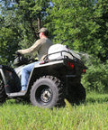 15 Gallon ATV Boomless Broadcast Sprayer With 16 Foot Swath, 2.2 GPM On Demand Diaphragm Pump mounted on ATV in field