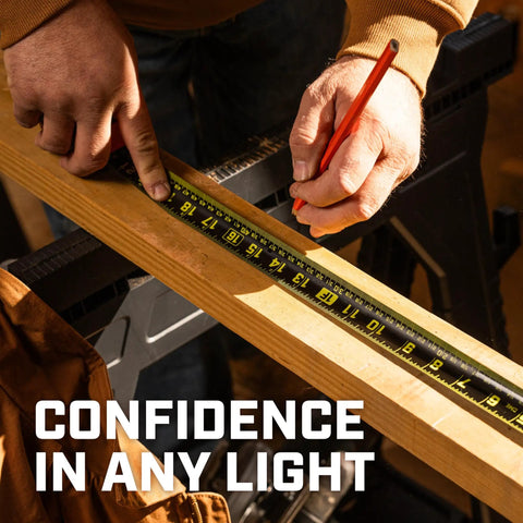 Close-up of a builder using the Workhorse Nite Eye Tape Measure 25 Ft 2 Pack With High Contrast Blade for precise measurements in low light.