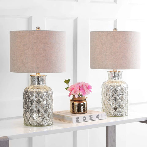 Alvord Mercury Silver Quatrefoil Glass Table Lamps Set of 2 with grey drum shades on a console table beside decor items.