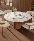 53 Inch Round Dining Table With Smooth Rotating Lazy Susan And Solid Hourglass Base Delivers A Clean Marble Look Top Crafted For Relaxed Weekend Hangouts Seats 6 To 8 In Brown with white chairs and flowers.