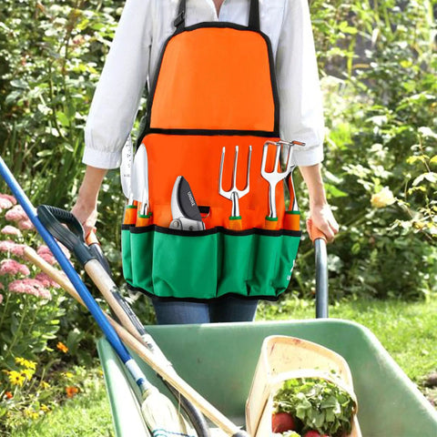 Person wearing a canvas apron with tools from 12 Piece Aluminum Garden Tool Set With Canvas Apron And Storage Pocket while gardening.