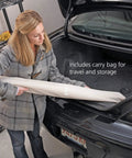 Woman placing Extra Wide Doorways Fabric Baby And Pet Gate Pressure Mounted For Openings 38 To 60 Inches into car trunk
