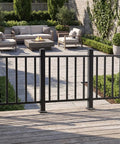 Heavy Duty Modular Deck Railing Kit, 36 By 3 Foot Black Porch Rails With Single Post, overlooking a patio with fire pit.
