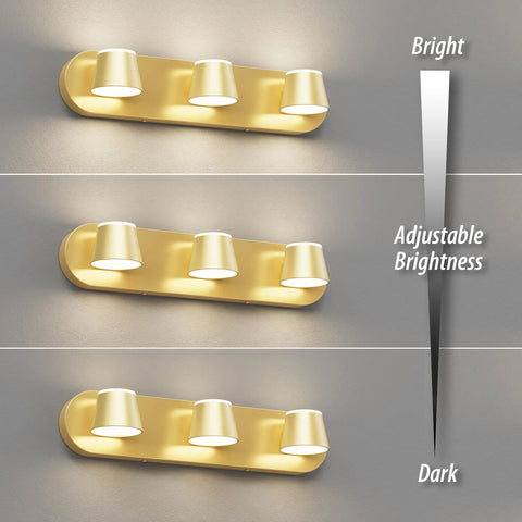 Gold three-light LED fixture demonstrating adjustable brightness levels on a wall.