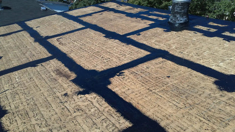 Kickass Rubberized Waterproofing Sealant For Foundations And Flat Low Slope Roofs Concrete Wood Metal Black Five Gallon Multi Purpose Coating applied on a damaged flat roof.