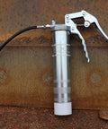 One Hand Pistol Grip Grease Gun Kit with SafeLock Coupler and Zinc Plated Barrel on rusted metal surface