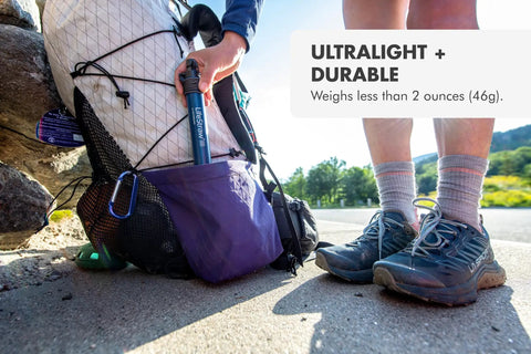 Person placing Personal Water Purifier For Hiking Camping Travel And Emergency Prep Delivers Safe Drinking Water into backpack pocket