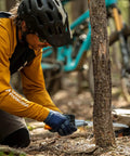 Person using GomBoy Curve Professional Folding Saw 240mm With Impulse Hardened Teeth on tree in forest