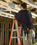 Construction worker on ladder using Leather Four Pocket Tool Pouch For Belt Holster in wooden building frame