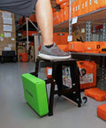 2 In 1 Mechanic Stool And Step Stool With Rolling Seat Adjustable Height Thick Padded Vinyl Cushion 300 Lb Capacity Five Swivel Casters For Auto Repair And Shop Tasks Pro Grade Comfort in a garage setting with foot on step