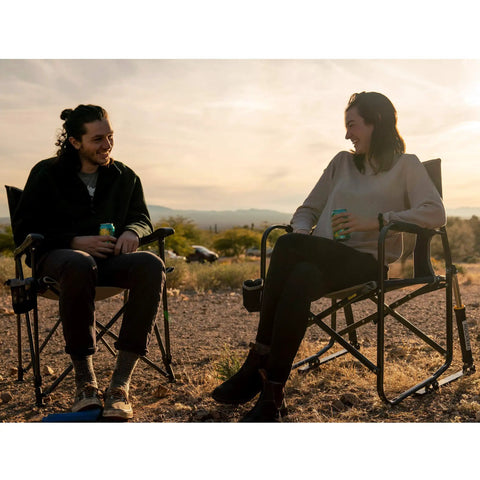 Two adults sitting on Ultra Easy Fold Up Outdoor Camping Chair For Adults With Mesh Back And Wide Seat Sturdy Powder Coated Steel Frame in a scenic outdoor setting