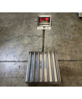 Heavy Duty Roller Top Bench Scale 18 X 18 Inches 500 Lb Capacity NTEP Legal Digital Platform with rollers on a concrete floor.