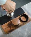 54mm Espresso Tamping Mat And Pro Grade Desk Ready Tool Organizer For Breville Espresso Machines Walnut Wood And Leather Tamp Station With Multi Slot Design For Tamper Distributor Funnel Puck Screen Storage And Dock in use on a marble counter top