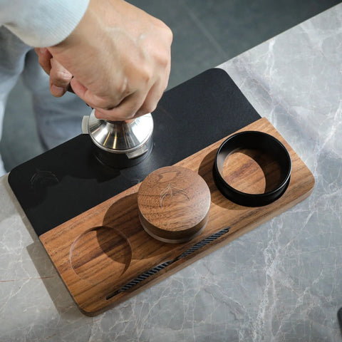54mm Espresso Tamping Mat And Pro Grade Desk Ready Tool Organizer For Breville Espresso Machines Walnut Wood And Leather Tamp Station With Multi Slot Design For Tamper Distributor Funnel Puck Screen Storage And Dock in use on a marble counter top