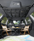 Interior view of SUV with installed overhead car cargo net with 3 pockets for extra roof storage on road trips and camping.
