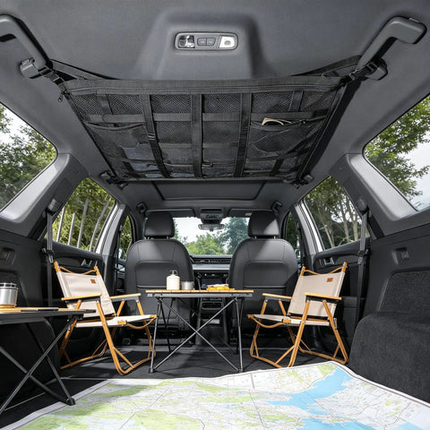 Interior view of SUV with installed overhead car cargo net with 3 pockets for extra roof storage on road trips and camping.