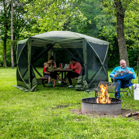 Instant Setup Pop Up Screen Tent No Tool Setup 11.5 Ft 6 Person Bug Free Outdoor Shelter For Camping Patio Backyard Tailgating, green gazebo canopy in use with people inside in a forest setting.