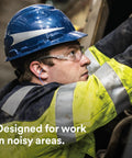 Worker with hard hat installing Heavy Duty Foam Ear Plugs For All Day Comfort Uncorded Disposable NRR 33 Ear Protection