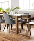 Modern dining room with hardwood floors and upholstered chairs around a wooden table