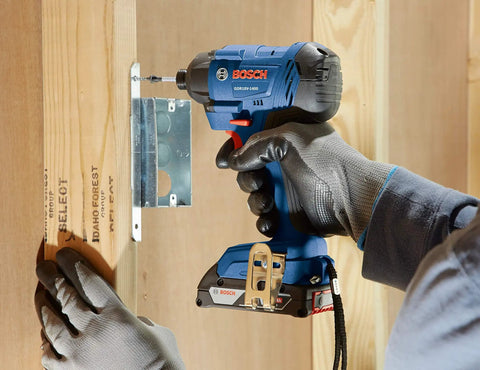 Person using 18V 1/4 Inch Hex Impact Driver Kit With 2Ah Battery, High Torque Up To 1,400 In-Lbs on wooden frame