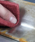 Roll A VFN Pro Grade Very Fine Aluminum Oxide Abrasive Roll 4 inch by 30 feet cleaning scratches on metal surface close-up