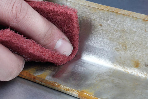 Roll A VFN Pro Grade Very Fine Aluminum Oxide Abrasive Roll 4 inch by 30 feet cleaning scratches on metal surface close-up