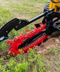 Workhorse Skid Steer Trencher Attachment with beefy steel frame and tungsten carbide teeth in action on rocky soil