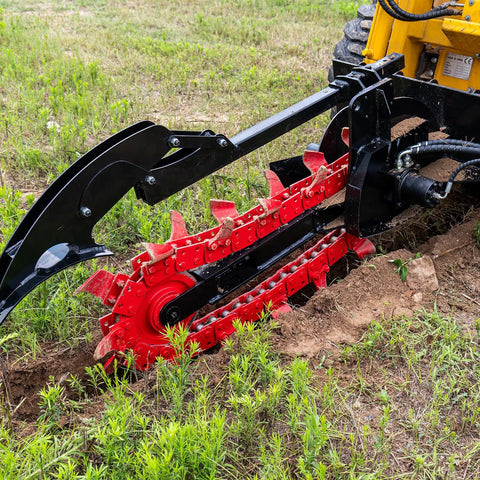 Workhorse Skid Steer Trencher Attachment with beefy steel frame and tungsten carbide teeth in action on rocky soil
