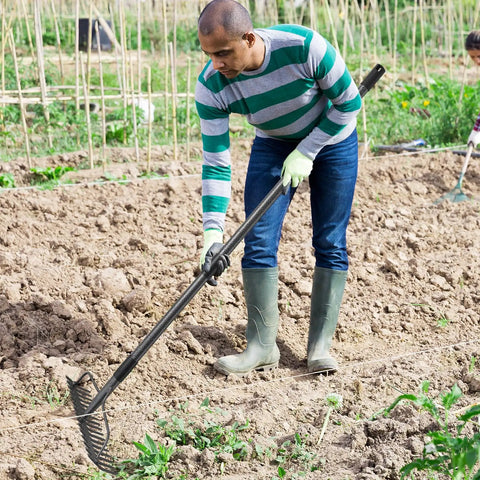 Person using 63 Inch Bow Rake Heavy Duty Garden Rake With Stainless Steel Handle And Metal Head For Loosening Soil and Leaf Cleanup