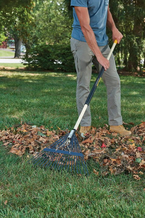 Person using Sturdy Steel Tine Leaf Rake With Hardwood And Steel Handle For Lawns And Dethatching 22 Tines 21.6 Inch Head Black