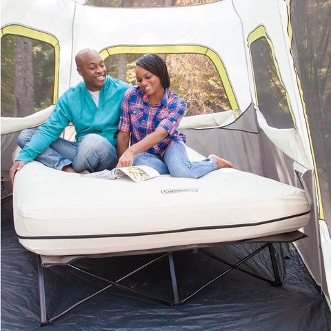 Couple sitting on Queen Size Airbed Cot With Folding Steel Frame And Side Table Battery Pump Included Portable Camping Bed For Indoor Outdoor Use