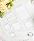 Set Of Six Clear Acrylic Styling Blocks And Flat Lay Props Ideal For Wedding Centerpieces And Product Shoots, a flat lay with blocks and a ring.