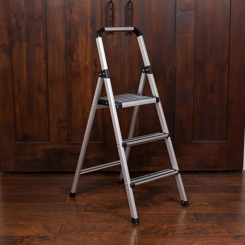 Lightweight Aluminum 3 Step Ladder With Wide Non Slip Steps Foldable Stepladder For Kitchen Pantry Closets And Home Office Space Saving Indoor Use Handy Portable Step Stool Durable Silver Finish, folded open on wood floor