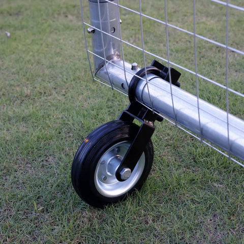 Tough As Nails 6 Inch Metal Gate Wheel for Swing Gates Up To 2 Inches Wide on grass, showing solid rubber tread and galvanized design.