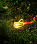 Heavy Duty Outdoor Extension Cord 75 ft Waterproof With Lighted End in a grassy outdoor setting, showing the illuminated plug.