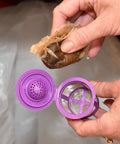 Straight Up Heavy Duty Unbleached Paper Filters With Lid For Reusable K Cups 700 Count Box shown being inserted into purple reusable cup.