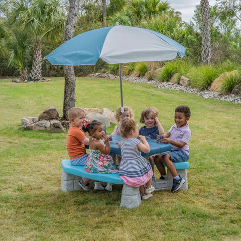 Children playing on Sun And Fun Picnic Table With Umbrella For Indoor And Outdoor Use Toddler Sized Table With Five Foot Shade Canopy.