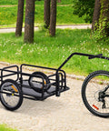 Foldable Bike Cargo Trailer With Hitch Tow-Behind Wagon, 88 Lb Capacity, Black Utility Cart attached to a bicycle on a path