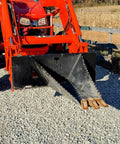 Stump Bucket For Tractors And Skid Steers Up To 105 HP With Bi Directional Ripping Edge attached to a red tractor on gravel