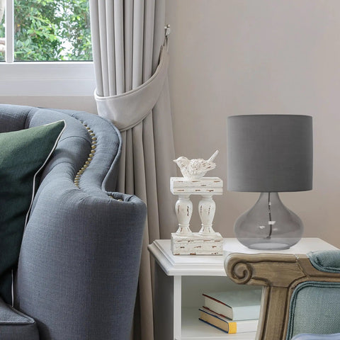 Small Glass Raindrop Bedside Table Lamp with Clear Glass Base and White Fabric Shade on side table in cozy living room