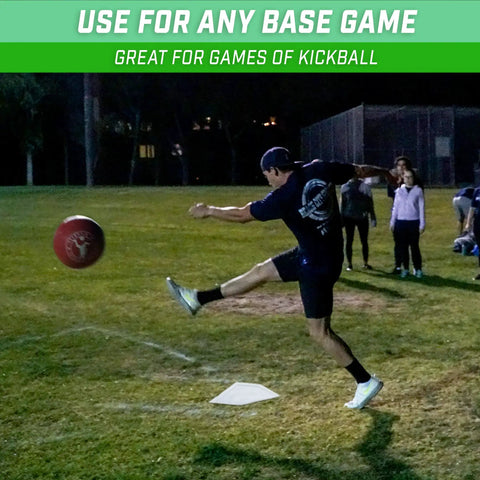 Man playing kickball using Baseball And Softball 5 Piece Base Set With Home Plate, Three Bases, And Pitching Rubber on grass field