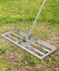 30 By 10 Inch Stainless Steel Lawn Leveling Rake With 6-Foot Extra Long Handle in use on grass.