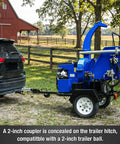 Blue 8 Inch Gas Powered Hydraulic Feeding Wood Chipper Shredder Towable With Tow Bar Electric Start behind a car on a farm